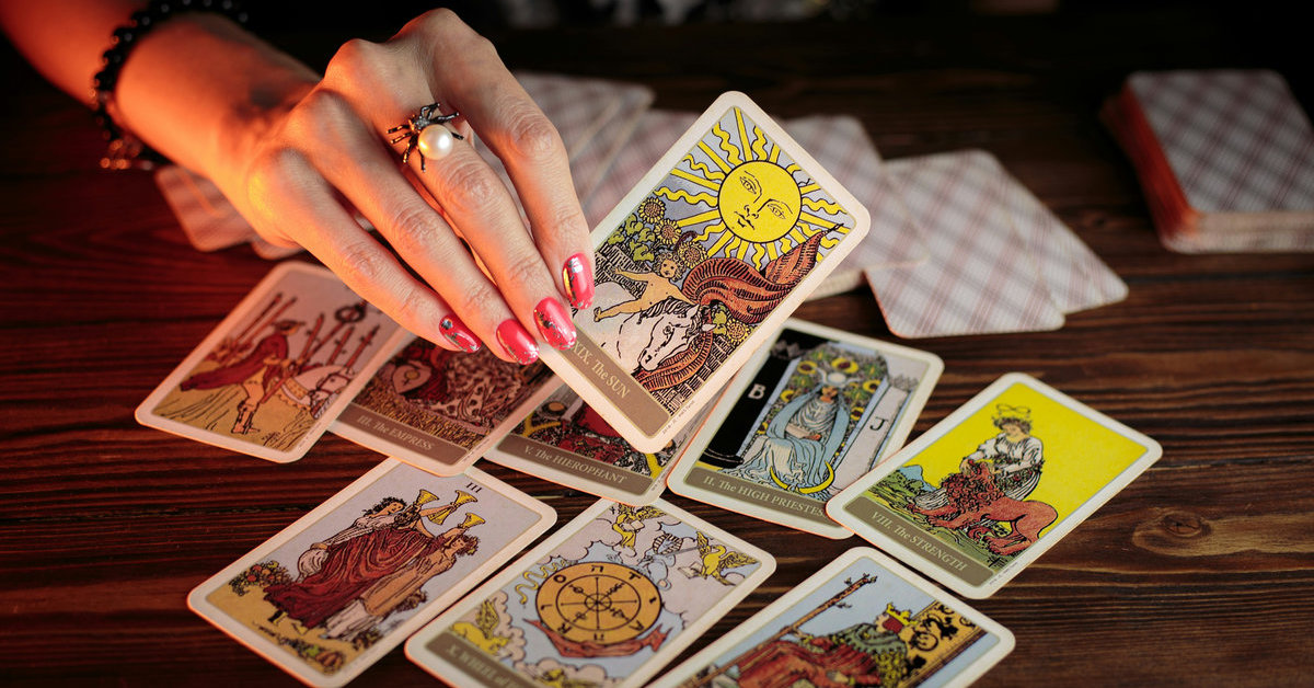 tarot cards with hand 1200x628
